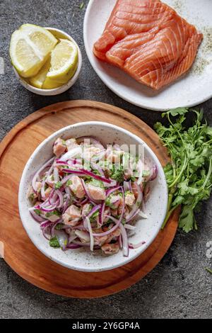 Food, Food, CHILEAN SALMON CEVICHE. Fresh raw salmon marinaded with purple onion, coriander in lemon juice. Sebiche and ingredientes on gray backgroun Stock Photo