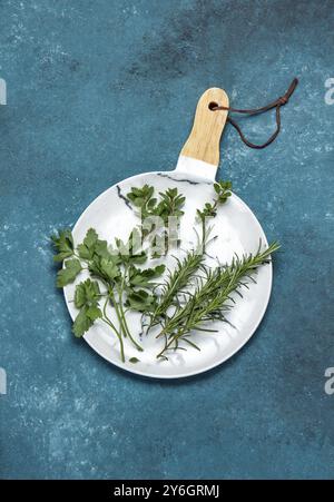 Food, Fresh herbs on white, blue background. Top view Stock Photo