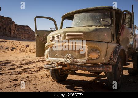 Wadi Rum, Jordan, March 2020: old rusty and worn-out broken vintage truck standing in the desert. Bullet holes in the windscreen. Abandoned vehicle, A Stock Photo