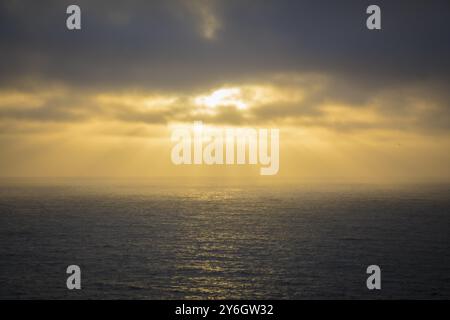 Golden Sunset Rays Over Calm Seascape Stock Photo