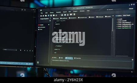Technician doing software quality assurance, reading source code on PC before implementing it. IT admin inspecting coding on computer, looking to fix potential issues, camera A close up Stock Photo