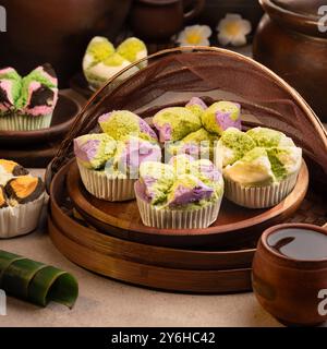 Steamed sponge cake, Bolu Kukus Mekar features a fluffy texture and vibrant colors. It's light, moist, and often topped with coconut or pandan. Stock Photo