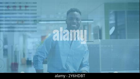 Image of diagrams and data processing over african american businessman smiling Stock Photo