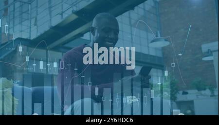 Image of diagrams over african american businessman using smartphone Stock Photo