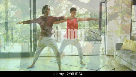 Image of autumn trees over diverse gay practicing yoga together at home Stock Photo