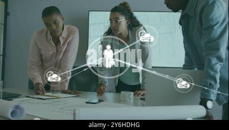 Image of network of connections with people icons over diverse business people in office Stock Photo