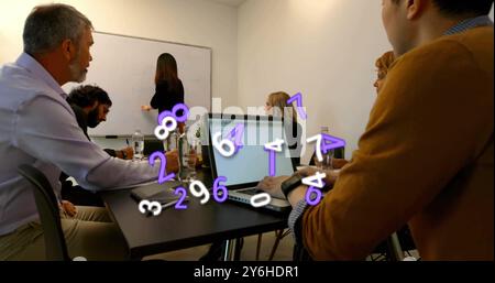 Image of numbers over diverse collleagues having meeting in office Stock Photo