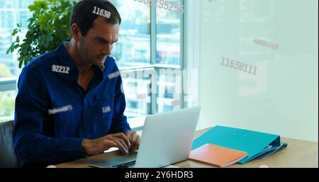 Image of data processing over biracial businessman using laptop in office Stock Photo