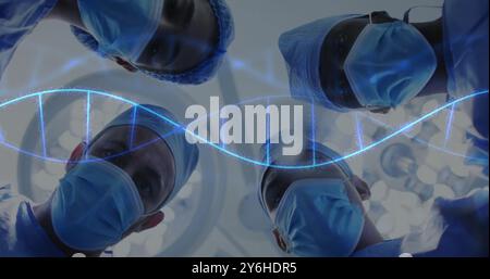 Image of dna strand spinning over diverse suergeons Stock Photo