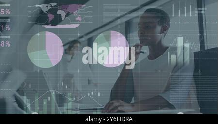 Image of financial data processing over african american businesswoman in office Stock Photo