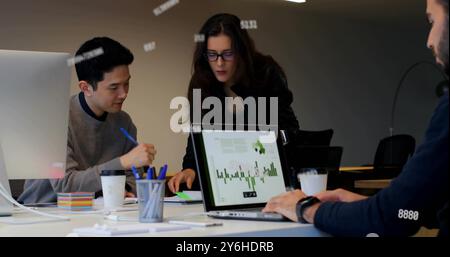 Image of data processing over diverse collleagues working in office Stock Photo