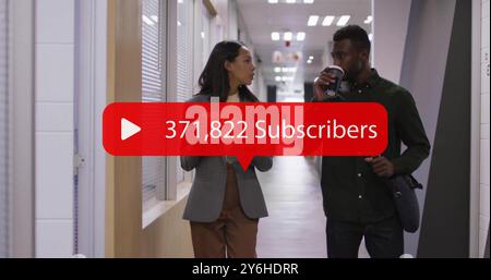 Walking in office hallway, two colleagues talking with 367,495 Subscribers image over them Stock Photo