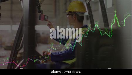 Image of financial data processing over asian male worker using lift truck in warehouse Stock Photo