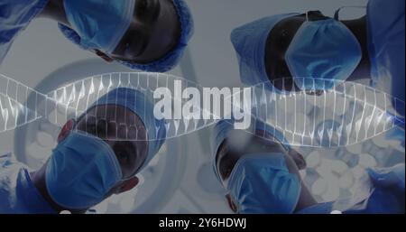 Image of dna strand spinning over diverse suergeons Stock Photo