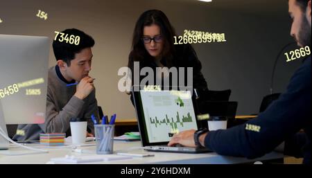 Image of data processing over diverse collleagues working in office Stock Photo