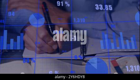 Image of financial data processing over caucasian businessman writing in office Stock Photo