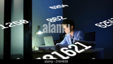 Image of data processing over caucasian businessman using laptop in office Stock Photo