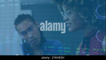 Image of financial data processing over diverse colleagues discussing work in office Stock Photo