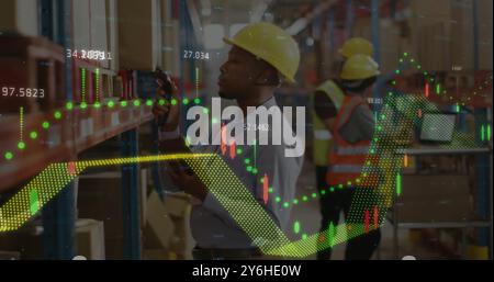 Image of financial data processing over biracial man working in warehouse Stock Photo