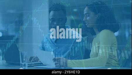 Image of financial data processing over diverse colleagues discussing work in office Stock Photo