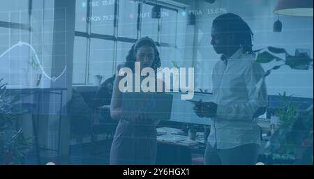 Image of financial data processing over diverse colleagues discussing work in office Stock Photo