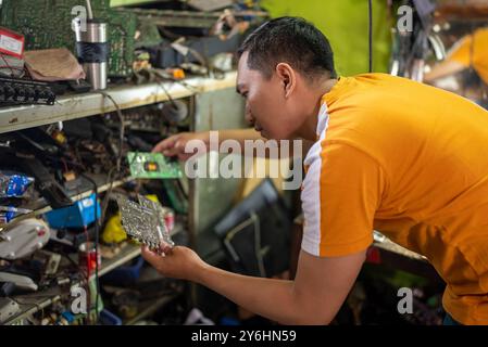 technicians view and compare printed circuit boards when replacing electronic circuits Stock Photo