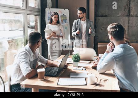Sharing interesting ideas. Two young colleagues conducting a business presentation while working in the creative office Stock Photo