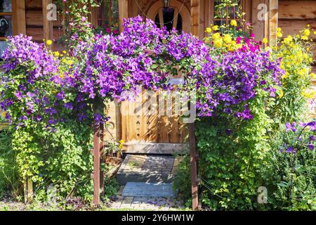 the flowers on the front gate form an arch Stock Photo
