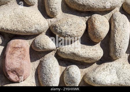 Wall background of various round stones Stock Photo