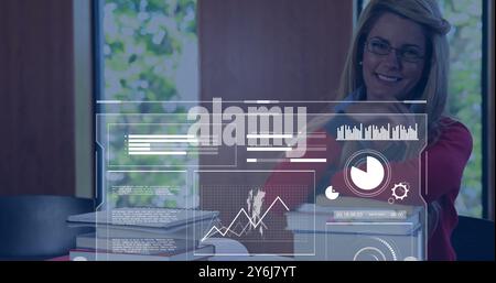 Image of charts processing over happy caucasian female student at desk with books Stock Photo