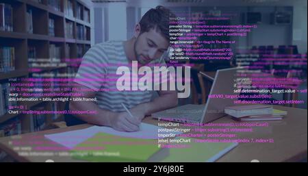 Image of data processing over caucasian male student using laptop and writing in library Stock Photo