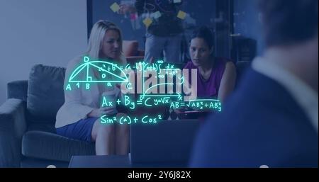Image of mathematical equations over diverse female colleagues using laptop at casual office Stock Photo
