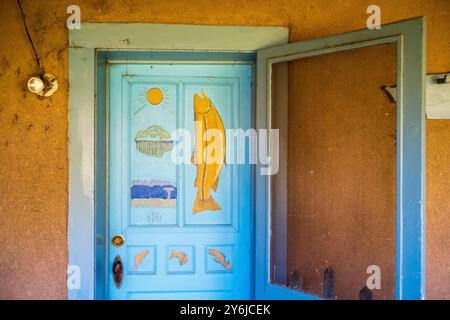 A fish painted on a turquoise door at the home of early 20th-century artists Ernest and Mary Blumenschein in Taos, New Mexico, USA Stock Photo