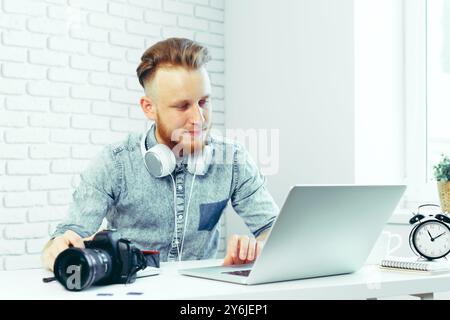 Photographer selecting photos on his computer Stock Photo