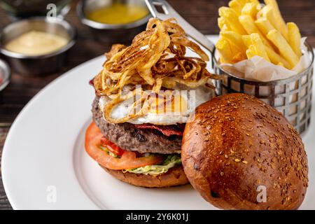 Burger with burger patty and egg on wooden table Stock Photo