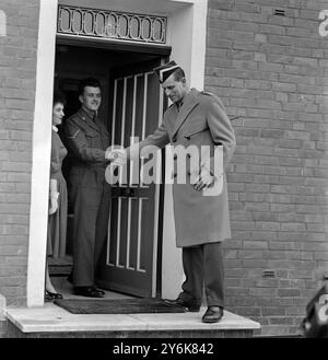 Prince Philip shakes hands with L Cpl Kelly and wife standing at the door of their quarters Stock Photo