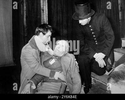 Magwitch played by Paul Curran dies in the arms of Pip played by Gary Watson a scene during rehearsal of the play Great Expectations adapted from the famous Charles Dickens novel at the Mermaid Theatre Puddle Dock  12 April 1960 Stock Photo