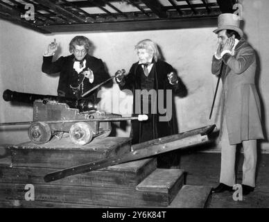 The cannon scene during rehearsal of the play Great Expectations adapted from the famous Charles Dickens novel at the Mermaid Theatre Puddle Dock showing Pip (as a man) played by Gary Watson  The Aged Parent played by Blake  Butler and Mr Wemmick played by Colin Ellis 12 April 1960 Stock Photo