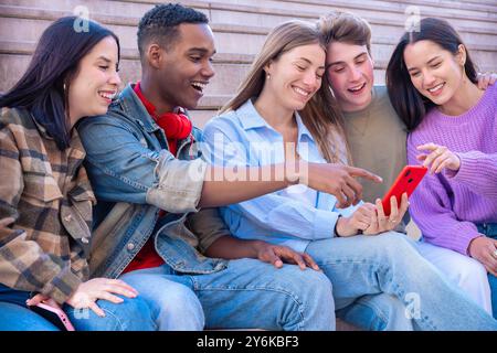 Students having fun with mobile phones creating content on social media. Stock Photo