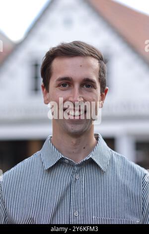 Photo of a Nordic young man smiling at the camera in Wyk city on Foehr island, Germany Stock Photo