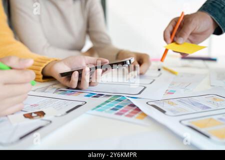 Collaborative UX UI Design Process with Team Working on Mobile App Prototypes and Wireframes Stock Photo
