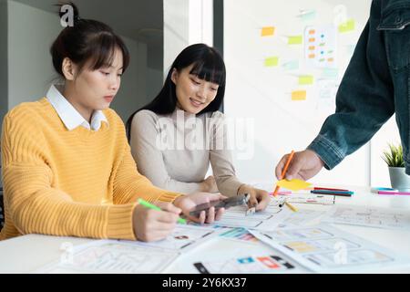 Creative Team Collaborating on UX UI Design Project with Wireframes and Prototypes Stock Photo