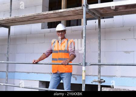 portrait smiling  construction manager / architect on site during the construction of a house - planning and control on site Stock Photo