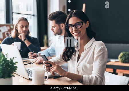 Confident and successful. Young modern colleagues in smart casual wear working while spending time in the office Stock Photo