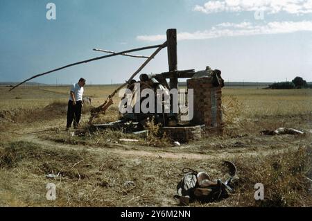 A man looking at an old watermill in 1950s rural Spain. Stock Photo