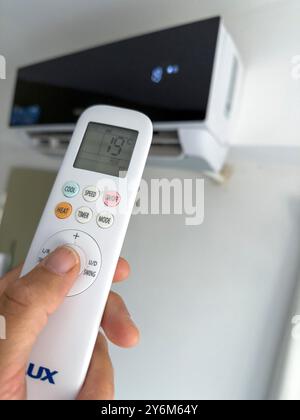 Air conditioner. Temperature adjustment by remote control at 19°C Stock Photo