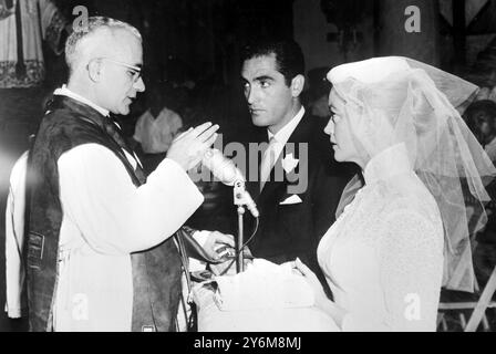 Hong Kong: Jacques Bergerac, former husband of Ginger Rogers, has a kiss for his new bride American film Actress Dorothy Malone after their marriage in Hong Kong performed by Father Camelo Orlando at Saint Teresa's Roman Catholic Church. Bergerac sought special dispensation by the Governor for the normal fifteen day waiting period, which would allow them to marry immediately Bergerac, Miss Malone and Miss Malone's mother arrived in Hong Kong Tokyo recently, where Miss Malone has been making a film  28 June 1959 Stock Photo