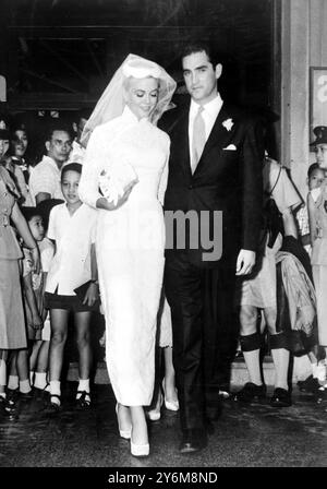 Hong Kong: Jacques Bergerac, former husband of Ginger Rogers, has a kiss for his new bride American film Actress Dorothy Malone after their marriage in Hong Kong performed by Father Camelo Orlando at Saint Teresa's Roman Catholic Church. Bergerac sought special dispensation by the Governor for the normal fifteen day waiting period, which would allow them to marry immediately Bergerac, Miss Malone and Miss Malone's mother arrived in Hong Kong Tokyo recently, where Miss Malone has been making a film  28 June 1959 Stock Photo