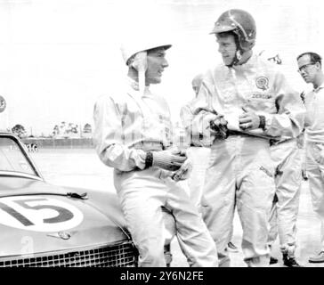 Sebring, Fla. USA: The British Motor Corporation has entered an experimental 110 M.P.H. car in Saturday us Sebring 12 hour endurance race, with Hollywood film Star Steve McQueen (right) at the wheel. Here Britain's racing driver Stirling Moss (left) chats making his international racing debut and moss driving Austin Healey Sprites arte members of the British Motor Corporation Team Steve McQueen a star of the western film, The Magnificent Seven, raced in Britain last year while making a new film, The War Lover.  His co-driver on Saturday will be John Colgate of the American toothpaste family. Stock Photo