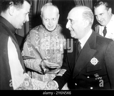 Barcelona: As Mgr MonZerat (left), is presented to Gerneral Franco, looking (centre) is the Papal Legate, Frederico Cardinal Tedischini, who opened the Eucharistic Congress here. On extreme right is Senor Artajo, the Spanish Foreign Minister. The picture was taken at a reception to night. Earlier today General Franco accompanied by his wife, had arrived in Barcelona for the congress, the first of its kind in 14 years. It is being held to 'acknowledge and expand the Kingdom of Christ.  The congress closes on June 1.  30 May 1952. Stock Photo